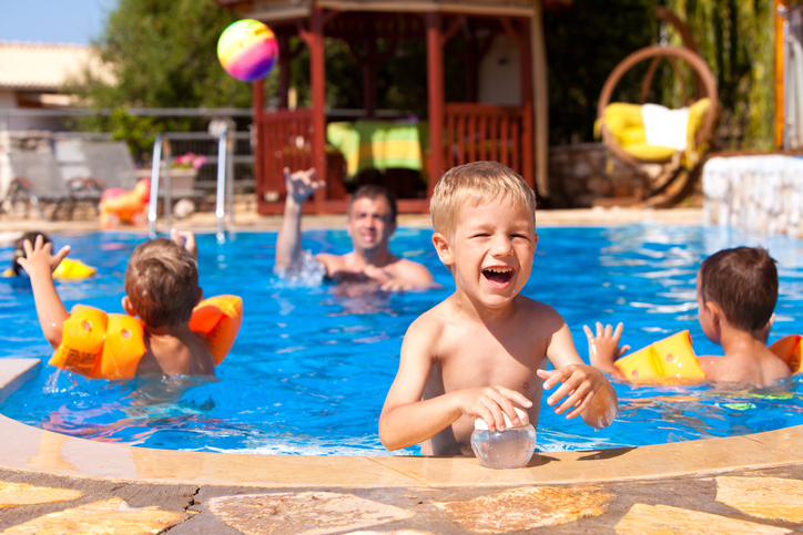 children play in a pool